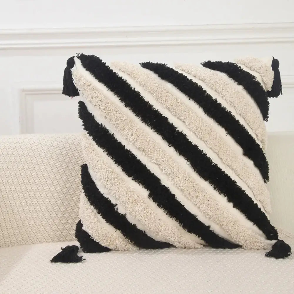 Boho geometric chenille embroidered pillow cover with black and cream diagonal stripes and tassels for living room decor