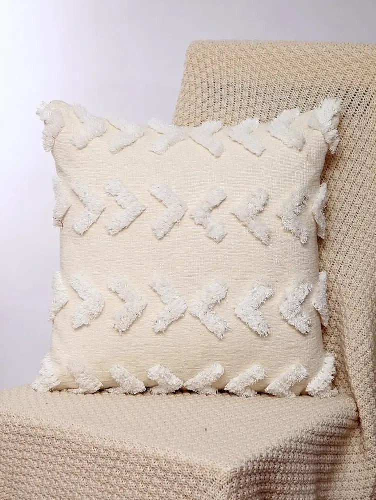 Cream-colored boho geometric chenille embroidered pillow covers with textured fabric and white tassel accents for living room decor
