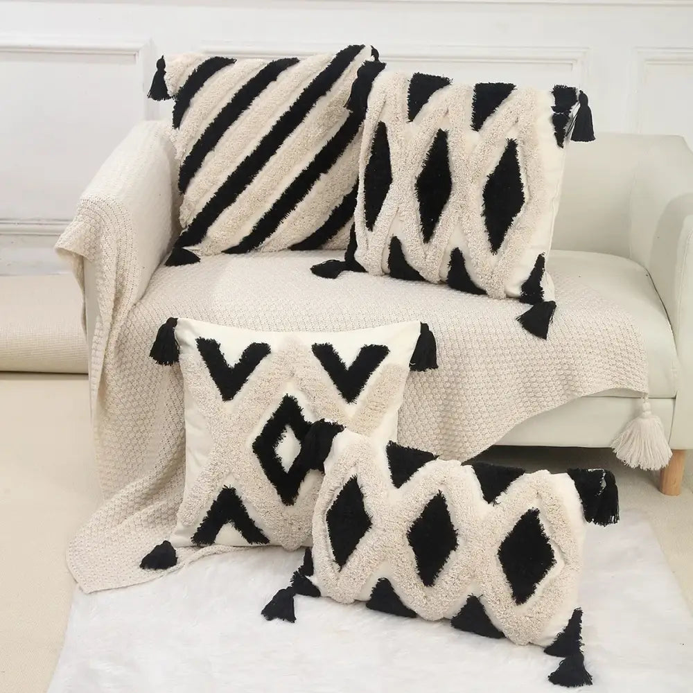 Set of four black and cream decorbites geometric chenille embroidered pillow covers with tassel accents for living room decor