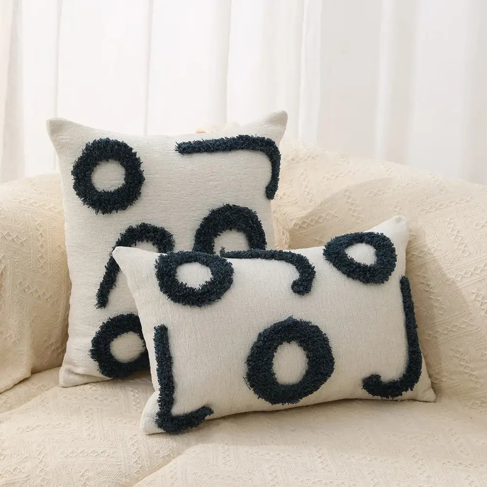 Cream-colored rectangular pillow covers with black fuzzy geometric chenille embroidered patterns for living room decorbites