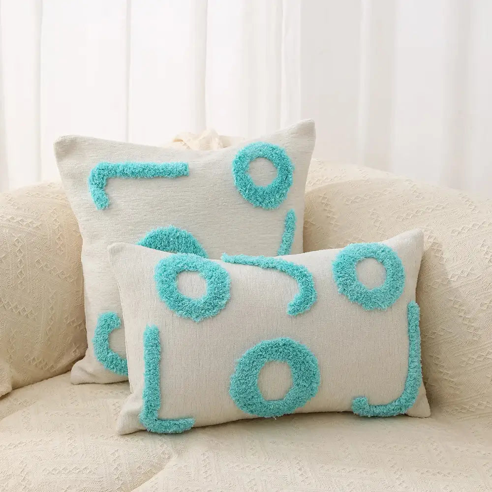 Cream-colored pillow covers with turquoise fuzzy geometric chenille embroidered patterns for living room decorbites