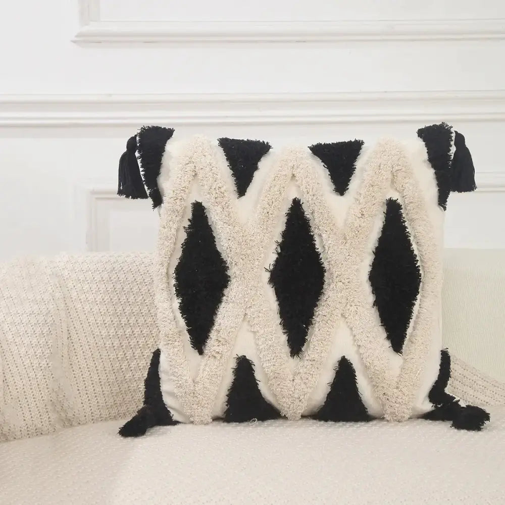 Black and cream-colored boho geometric chenille embroidered pillow covers with tassel accents for living room decorbites decor