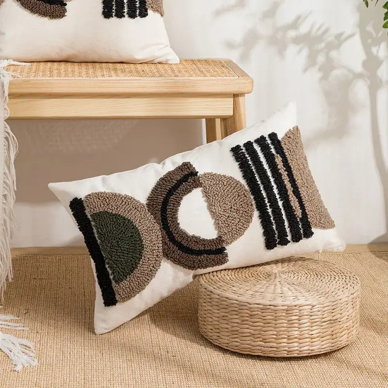 White rectangular cushion cover with decorbites geometric embroidery in beige black and olive green yarn tufts for living room decor