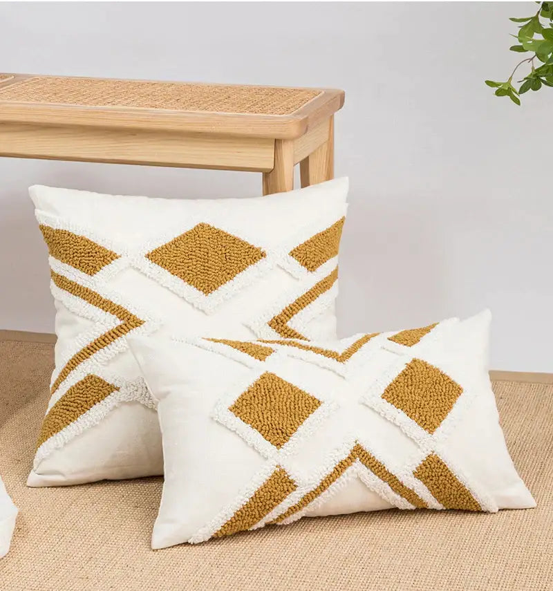Cream-colored cushion cover with mustard-yellow geometric embroidery boho tufted pattern for living room decorbites