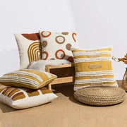 A collection of mustard and cream boho loop tufte cushion covers with embroidered geometric patterns for living room decorbites decor