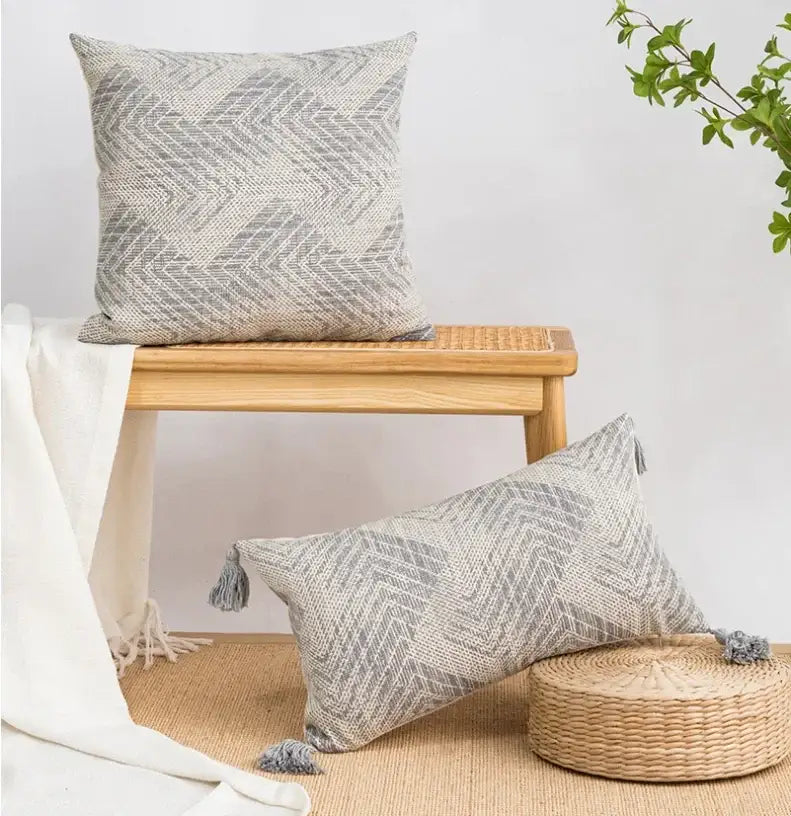 Gray woven cushion cover with geometric chevron pattern and tassels by decorbites boho loop for living room decor