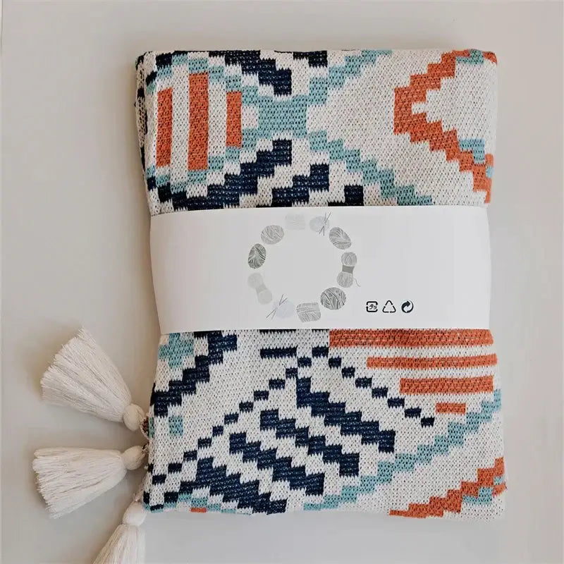Folded decorbites boho geometric summer blanket with navy blue teal orange white yarns and off-white tassels