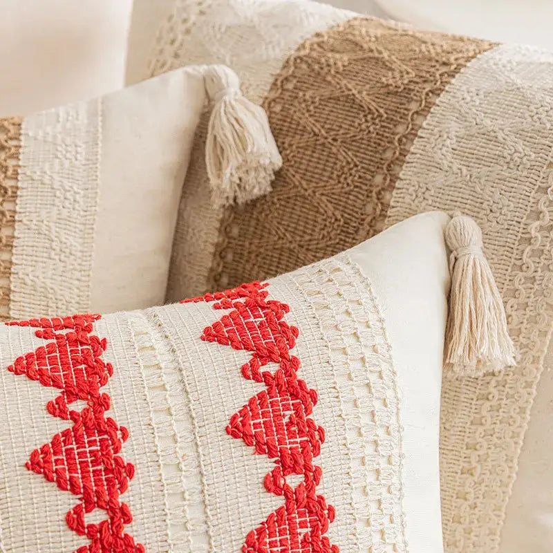 Cream-colored cushion cover with vibrant red embroidered boho geometric tassel patterns for living room decorbites style