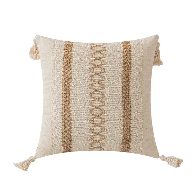 Beige throw pillow with textured woven stripes and matching tassels.