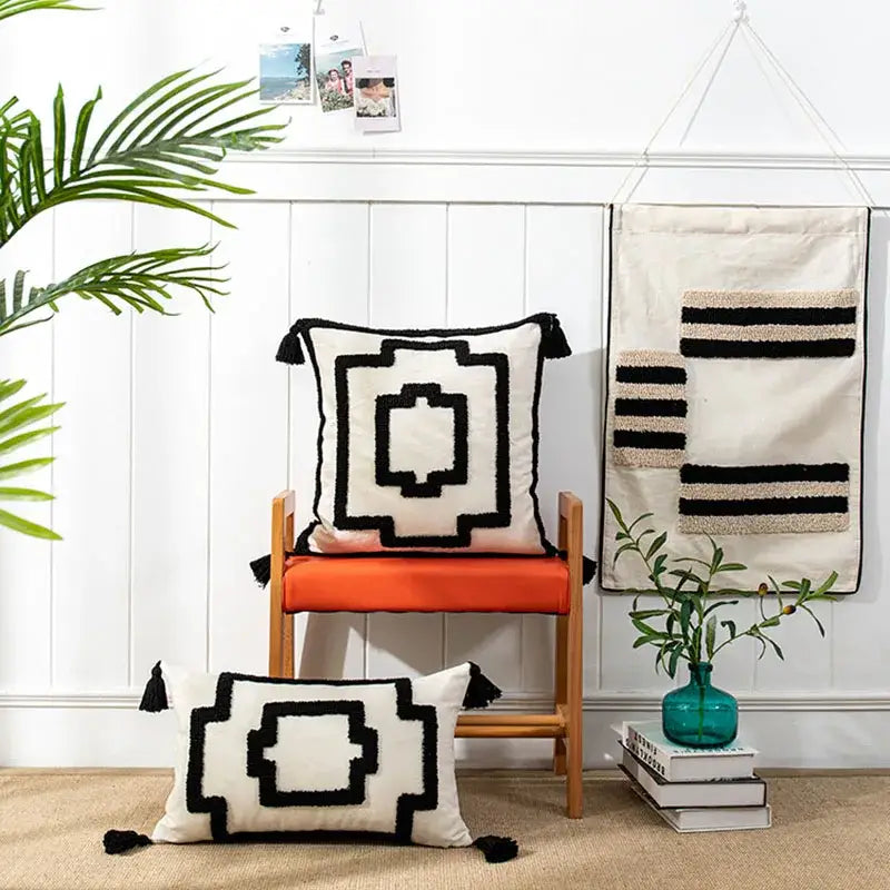 Cream-colored cushion cover with black geometric embroidery and tassel trim from decorbites boho geometric tufted series