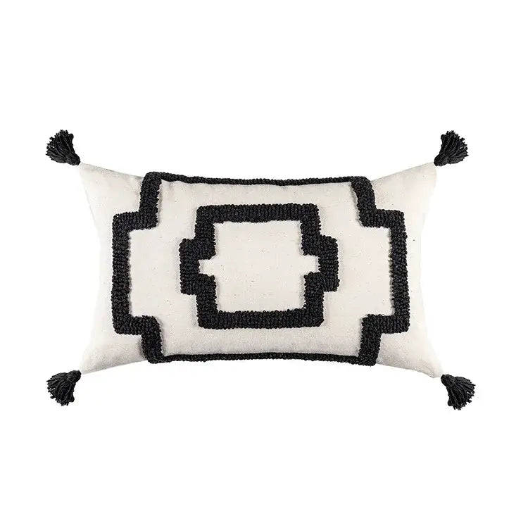 Cream-colored boho geometric tufted cushion cover with black embroidery and tassels for living room decor by decorbites
