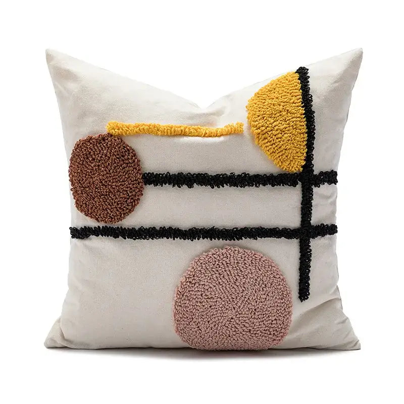 Cream-colored boho geometric tufted cushion cover with abstract brown yellow pink embroidery and black accents by decorbites