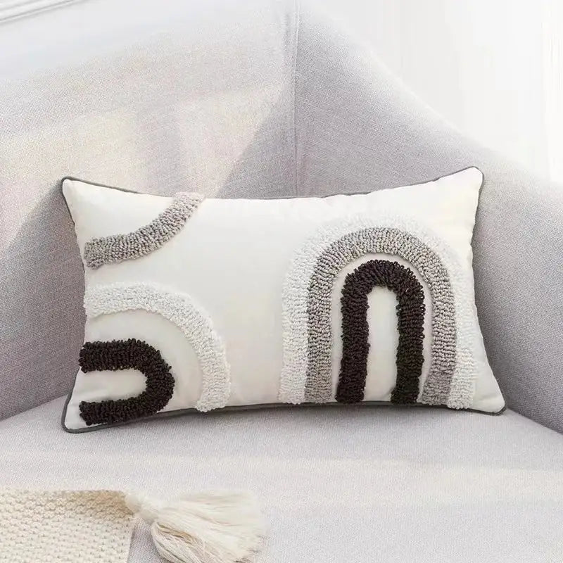 Rectangular white cushion cover with boho geometric tufted cream and gray textured rainbow design by decorbites