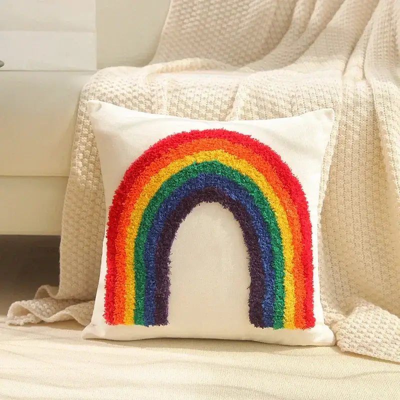 A cozy white cushion cover with a vibrant boho geometric tufted rainbow design for cream and gray decorbites living rooms