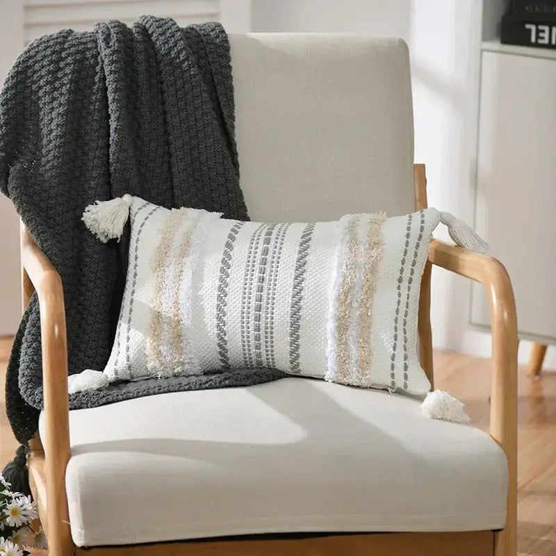 White rectangular cushion cover with boho geometric tufted cream and gray stripes and tassels by decorbites