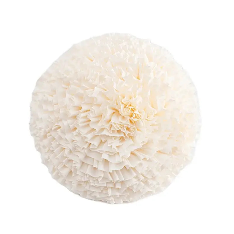 Off-white paper pom-pom with layered ruffled edges used as decorbites boho geometric tufted cushion cover decor