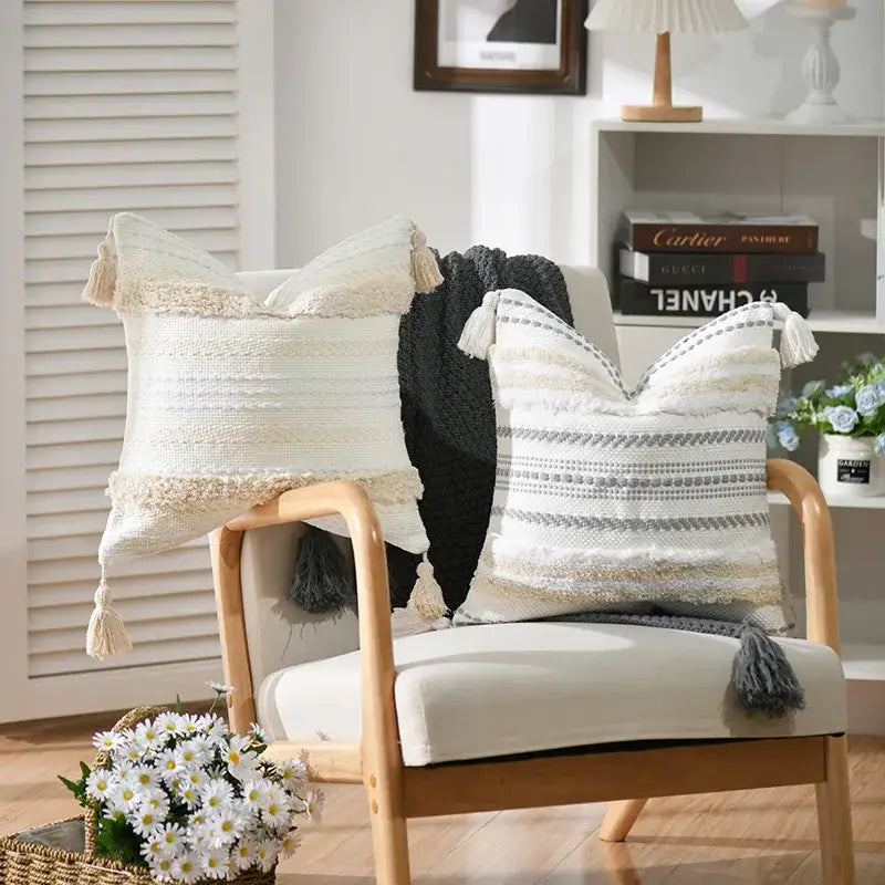 Two textured throw pillows with tassels featuring decorbites boho geometric tufted cushion cover in cream and gray stripes