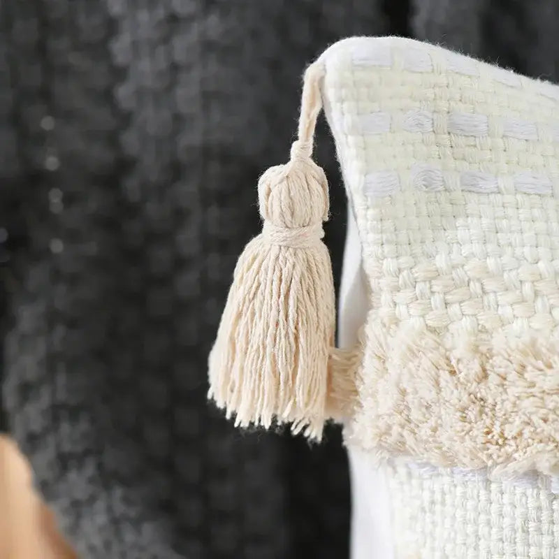 Cream-colored woven tassel on an off-white decorbites boho geometric tufted cushion cover for living room decor