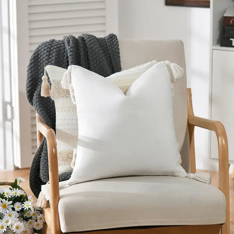 White square cushion cover with soft textured fabric and decorative tassels by decorbites boho geometric tufted style