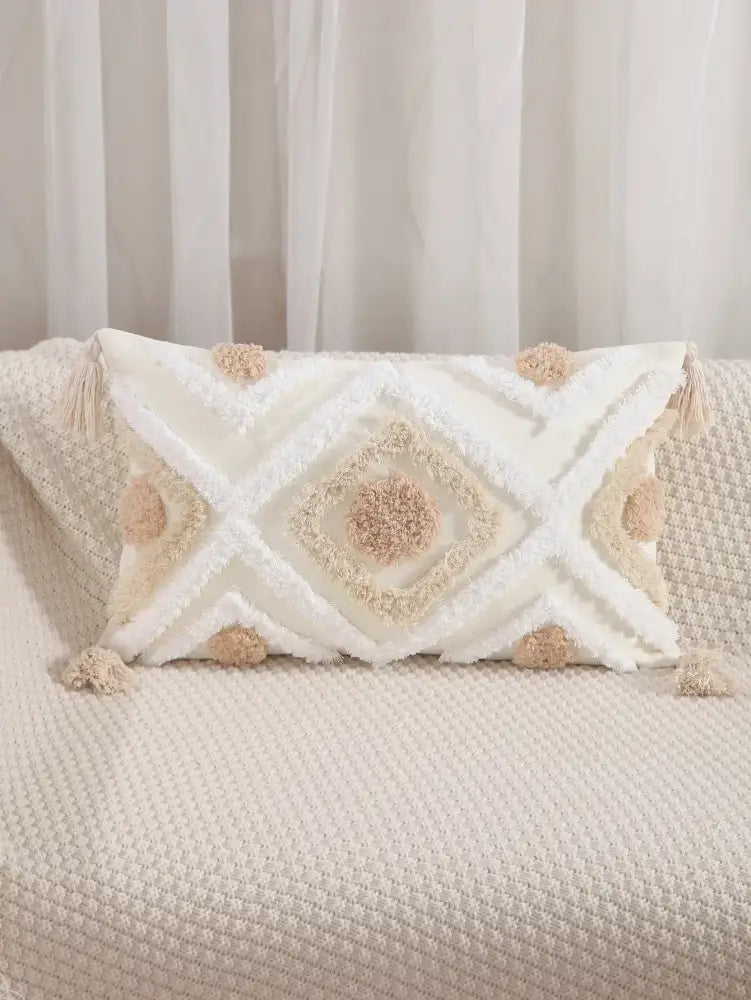 Cream-colored boho geometric tufted cushion cover with textured pattern and beige pom-poms for living room decorbites decor