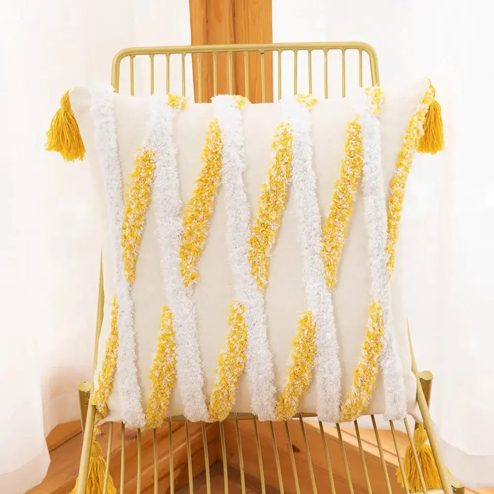 White and yellow tassel throw pillow with textured, woven stripes.