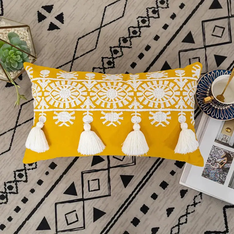 Vibrant yellow boho gold embroidered cotton pillow cover with intricate white patterns and tassels for living room decorbites decor