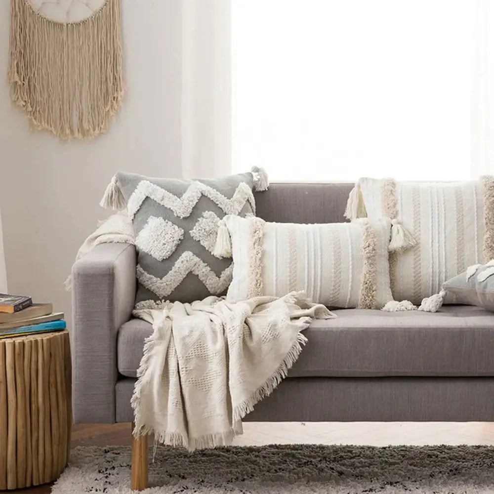 Gray sofa decorated with boho morocco tufted cushion covers and cream knit blanket for living room decorbites boho morocco