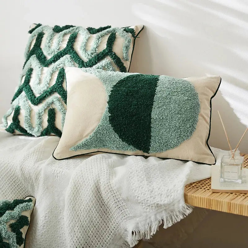Cream-colored cushion cover with plush green geometric design and black piping for boho decorbites blue tufted style