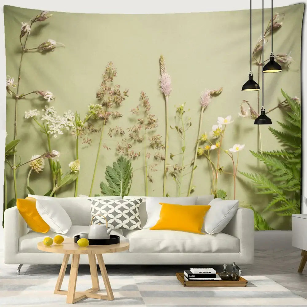 A soft sage green wall tapestry with detailed botanical print featuring tall grasses and wildflowers for boho green leaf decor