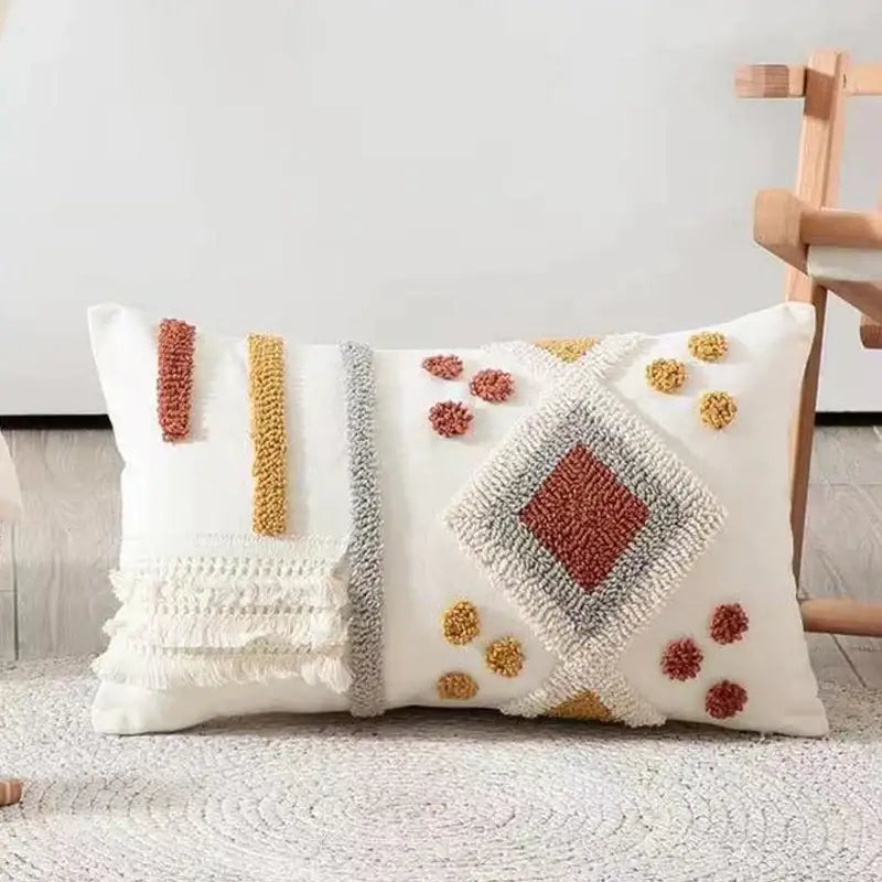 Cream-colored boho ivory brown tufted pillow cover with hand-tufted terracotta and mustard geometric decorbites design