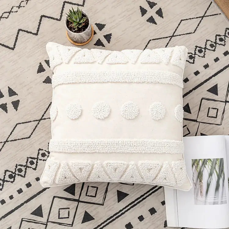 Cream-colored boho ivory cotton loop cushion cover with textured white tufted patterns and geometric designs for decorbites