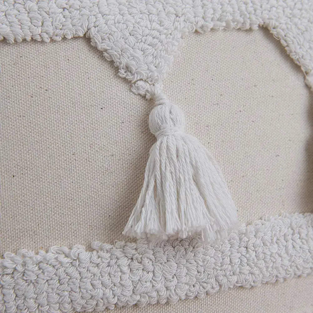 Boho ivory tufted tassel cushion cover with white tassel hanging from a textured cream fabric border for living room decor