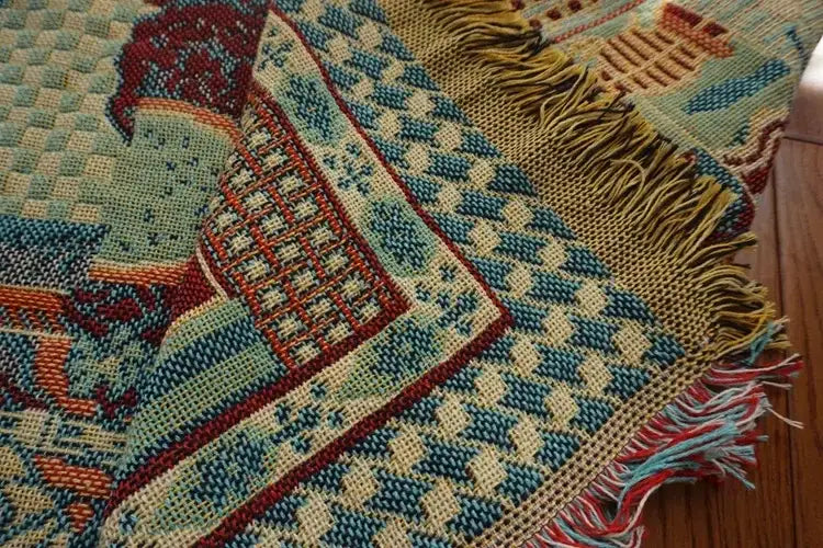 Colorful boho jacquard knit throw blanket with geometric patterns in red cream teal and blue featuring fringed edges decorbites boho jacquard decor