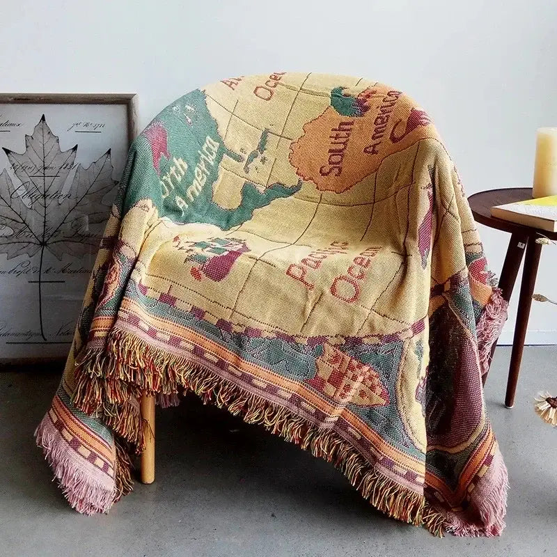 Boho jacquard knit throw blanket with vintage world map design in earthy beige green orange and pink tones for decorbites decor