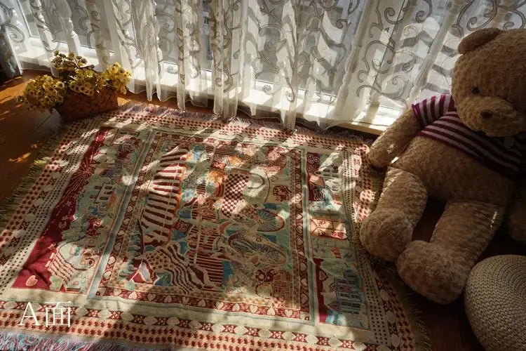A plush tan teddy bear beside a red and cream decorbites boho jacquard knit throw blanket in living room decor
