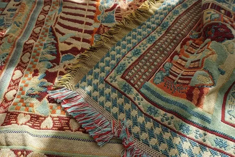 A decorbites boho jacquard knit throw blanket with intricate geometric designs in red and cream for living room decor