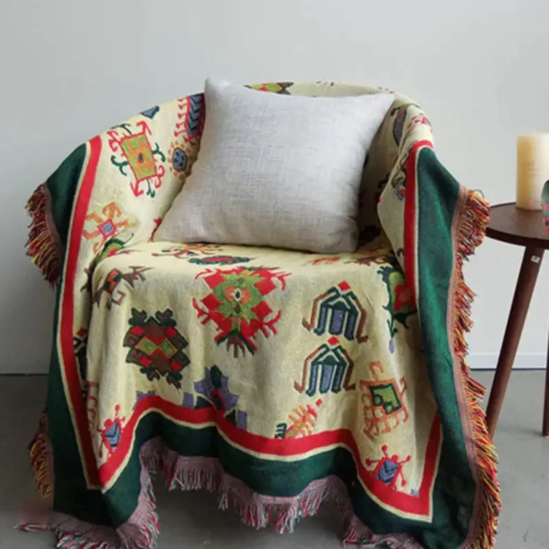 Cream-colored decorbites boho jacquard knitted throw blanket with vibrant geometric patterns and fringed edges