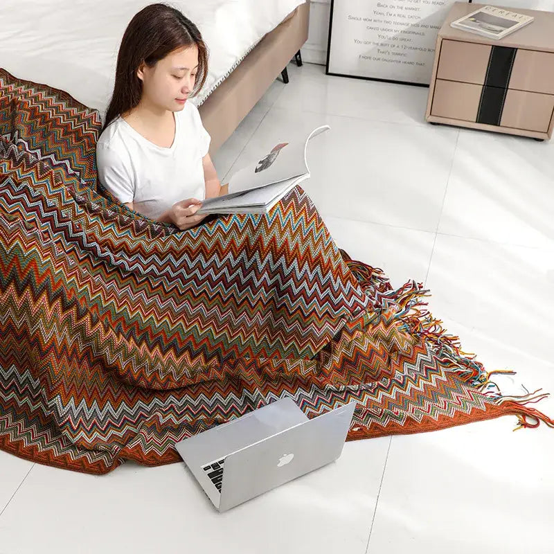 Bohob knitted striped living room throw featuring multicolored zigzag pattern with fringed edges in warm earthy tones