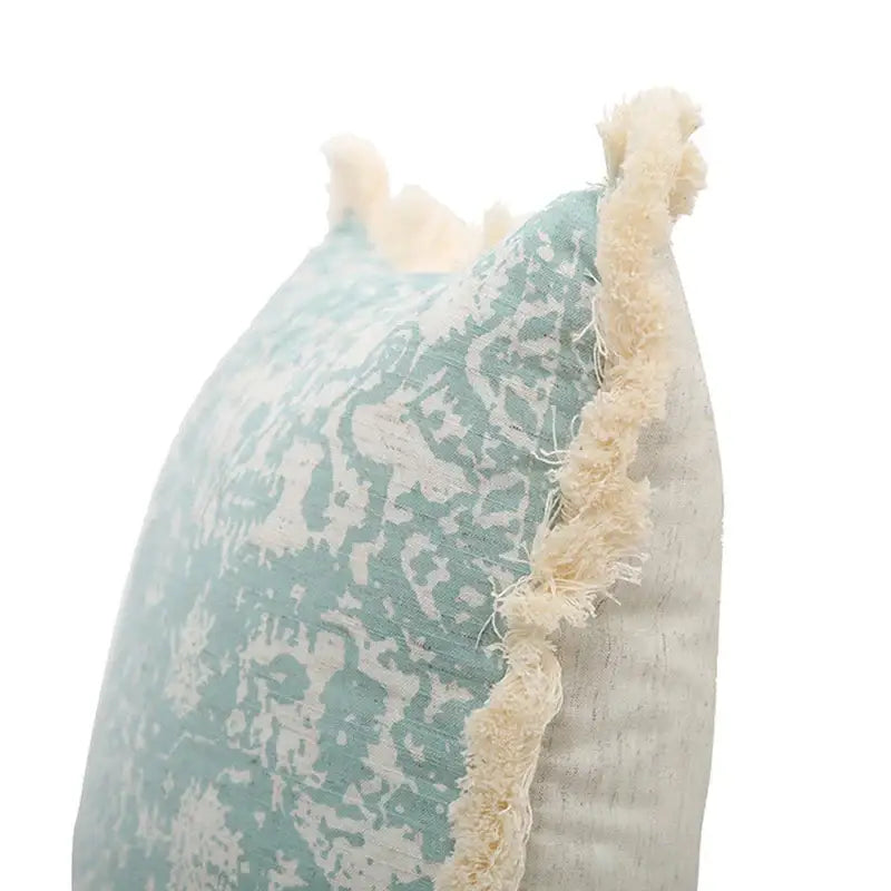 Boho light blue and white patterned pillow cover with teal cream distressed fabric and frayed edge trim decorbites green tassel