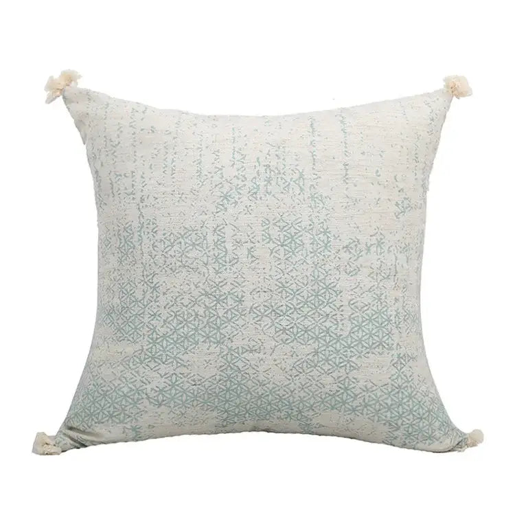 A soft off-white pillow cover with mint green geometric patterns and green tassels for boho decorbites green tassel decor