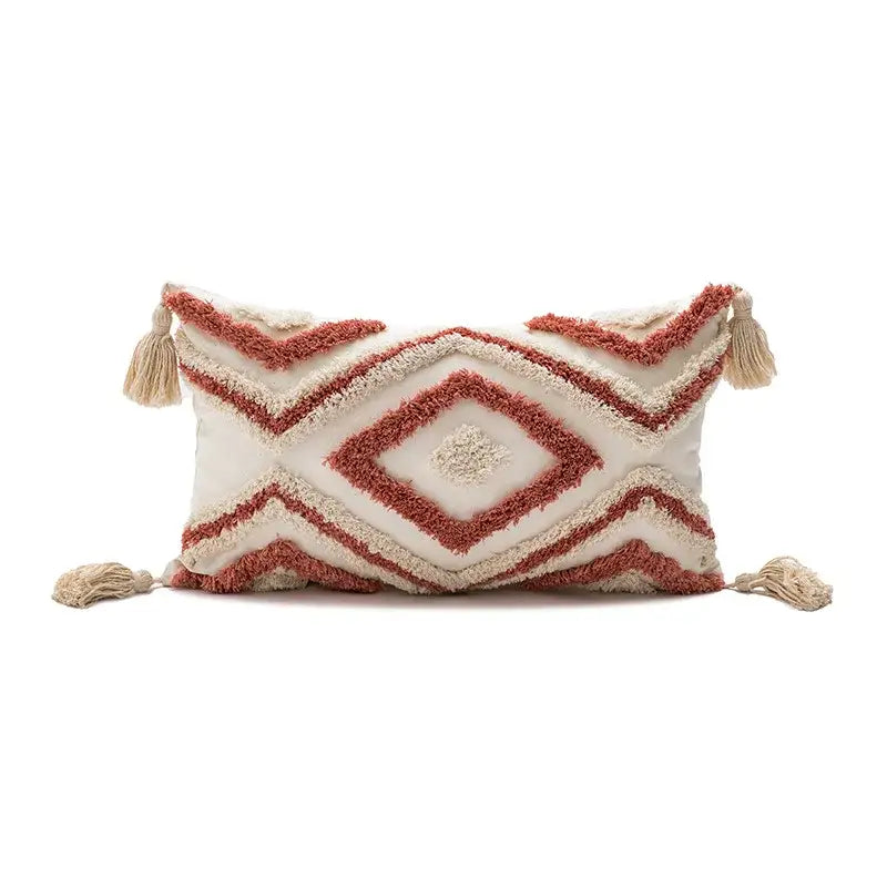 Cream-colored rectangular boho loop tufted pillow cover with rust-red geometric embroidery and tassels for decorbites decor