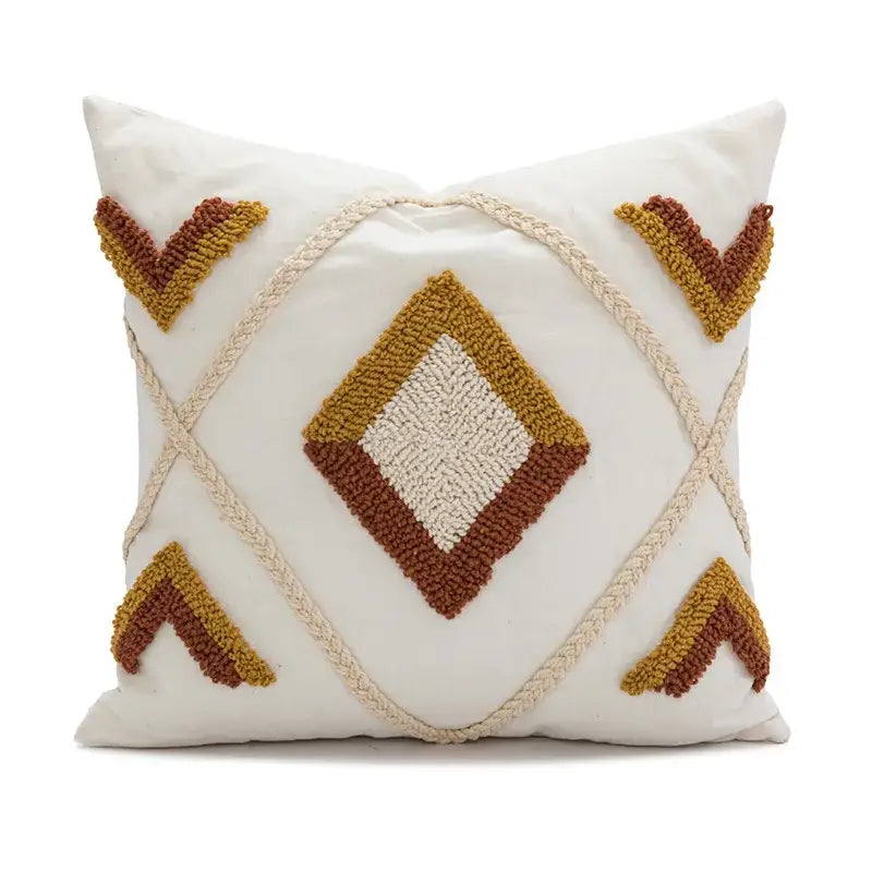 Cream-colored boho loop tufted pillow cover with textured geometric mustard and terracotta v motifs and braided rope accents