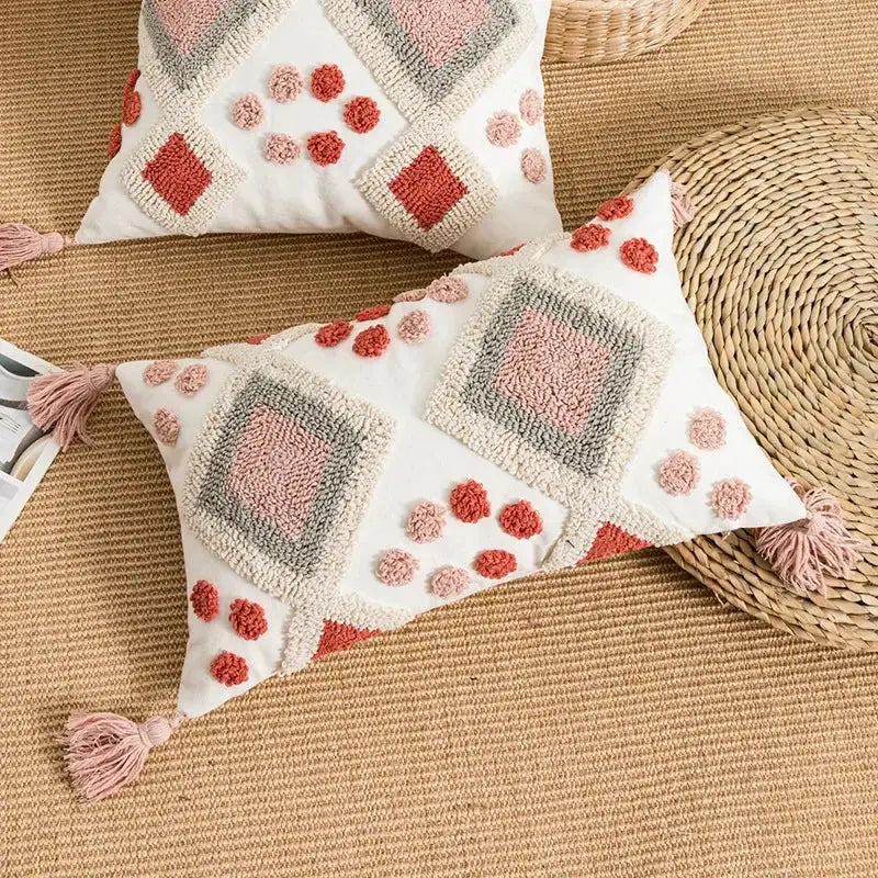 Cream-colored pillow cover with blush pink terracotta gray geometric patterns and tassels decorbites boho loop tufted design