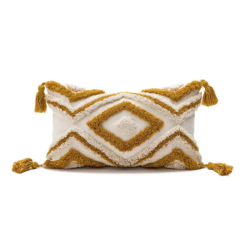 Cream-colored boho loop tufted pillow cover with mustard-yellow geometric embroidery and tassels by decorbites