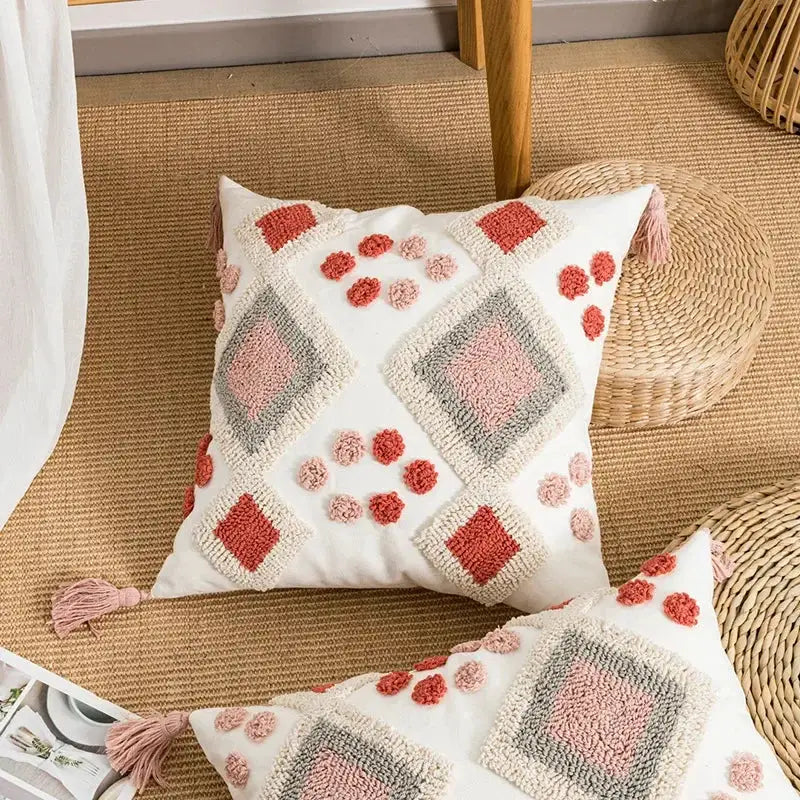 White throw pillow cover with coral embroidered diamonds and tassels in decorbites boho loop tufted style