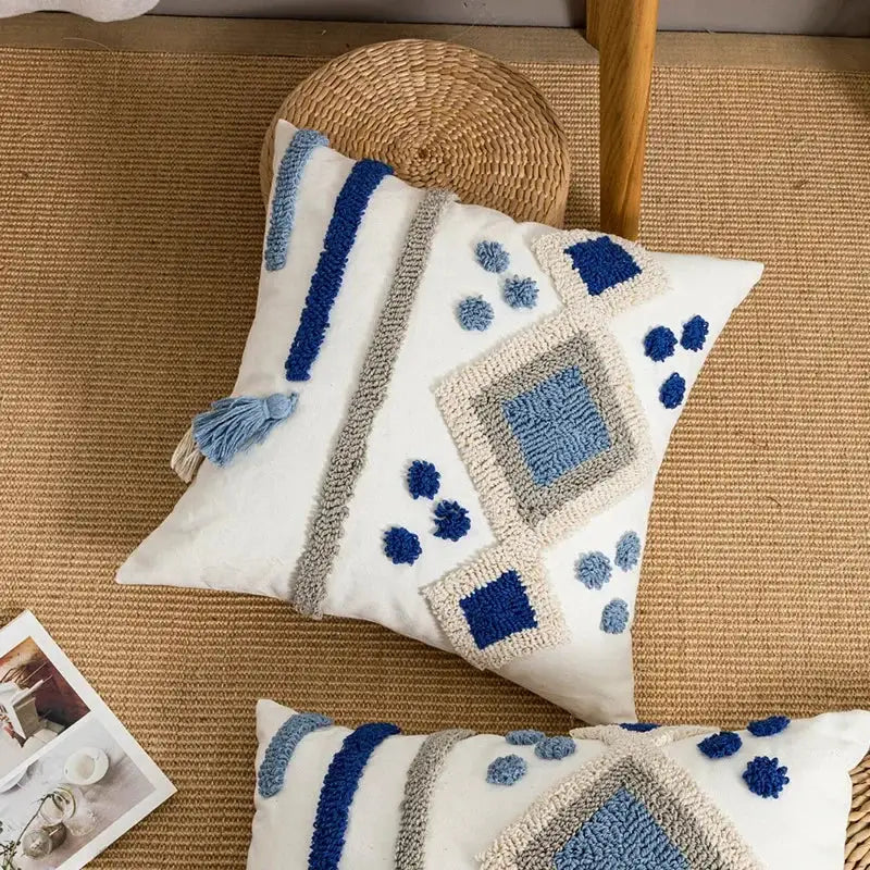 White throw pillow cover with blue and gray textured boho loop tufted geometric embroidery and tassels by decorbites