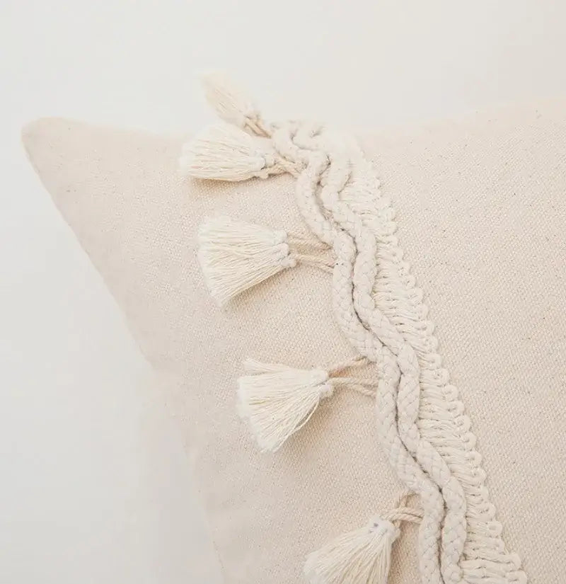Cream-colored boho macrame woven cotton cushion cover with textured border and matching tassels by decorbites boho macrame