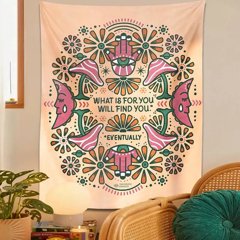 A soft peach-colored boho moon flower magic tapestry featuring vibrant pink and green faces and floral decorbites boho moon design