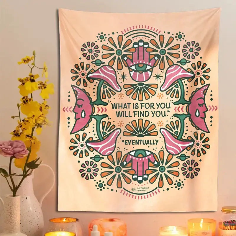 A soft peach-colored decorbites boho moon flower magic tapestry with vibrant pink and green faces and floral wall hanging