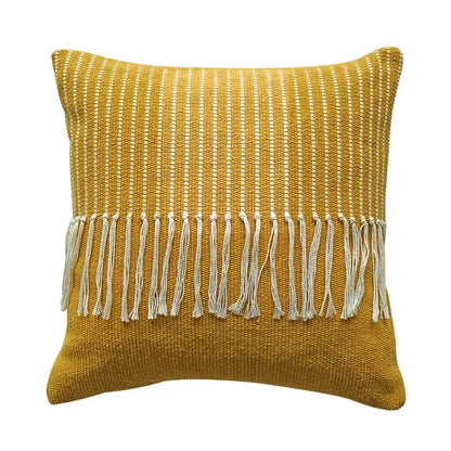 A mustard-yellow woven boho moroccan fringed pillowcase with textured pattern and white fringe for living room decor